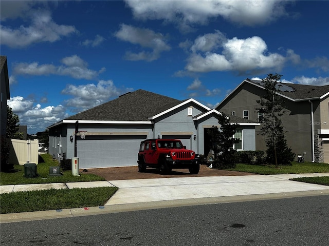 view of front of property with a garage and a front lawn