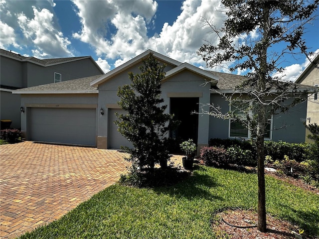 view of front of home with a front yard and a garage