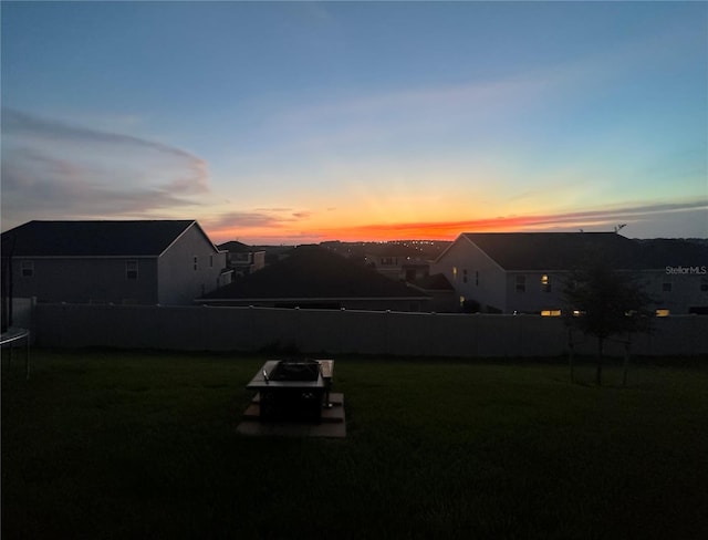 yard at dusk with a trampoline