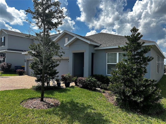 view of front of home with a garage and a front yard