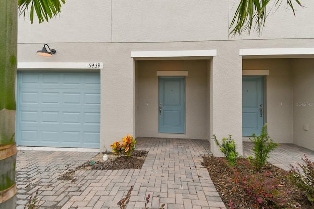 view of exterior entry with a garage