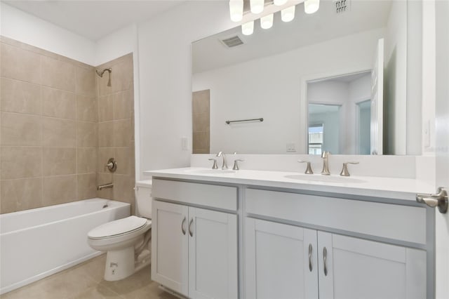 full bathroom featuring vanity, tiled shower / bath combo, and toilet