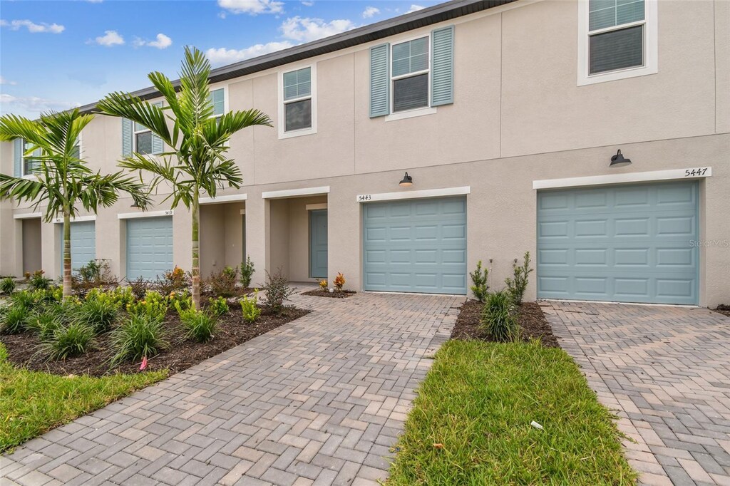 multi unit property featuring a garage