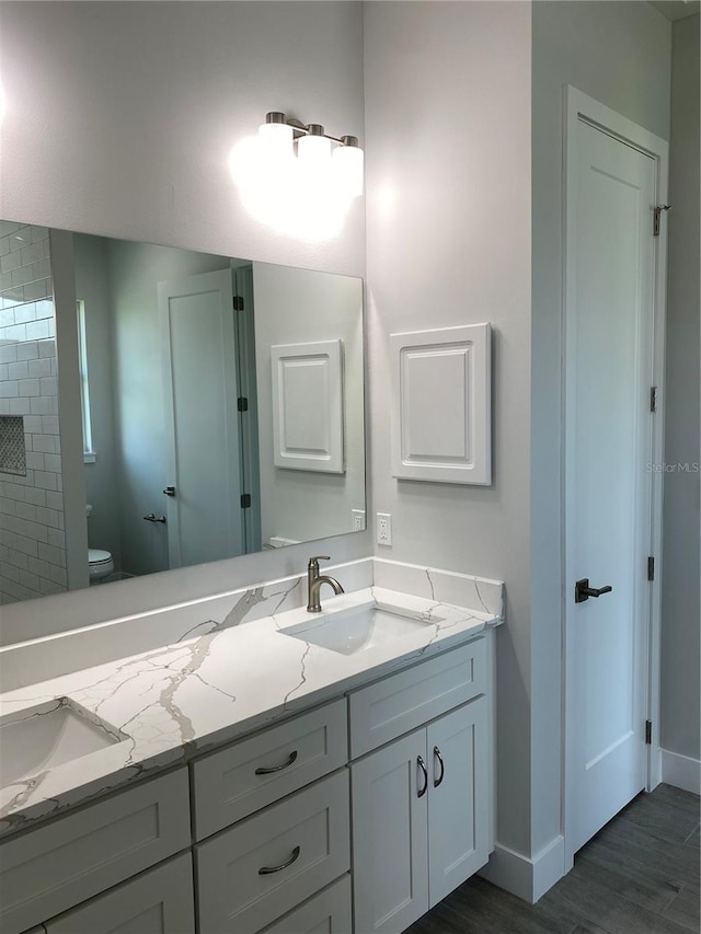 bathroom featuring hardwood / wood-style floors, vanity, and toilet