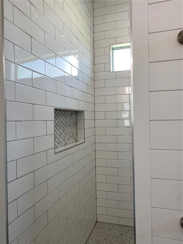 bathroom with a tile shower