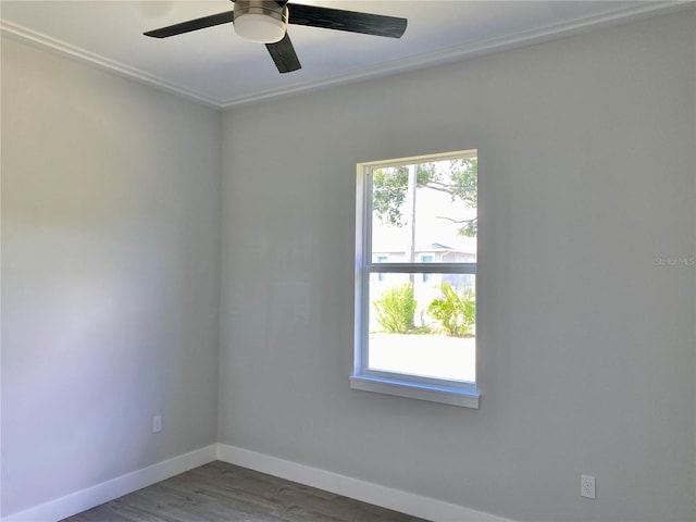 unfurnished room featuring baseboards, ceiling fan, and wood finished floors