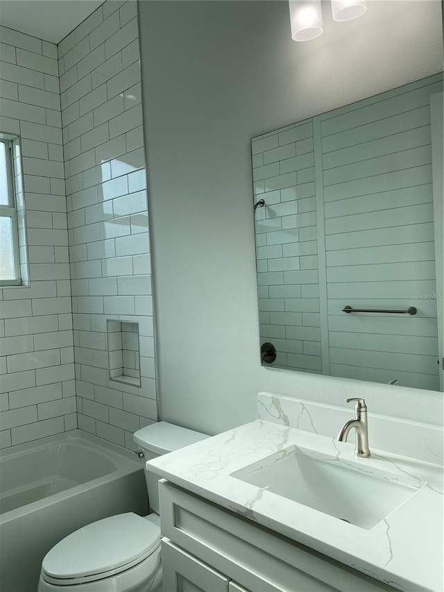 full bathroom with toilet, vanity, and  shower combination