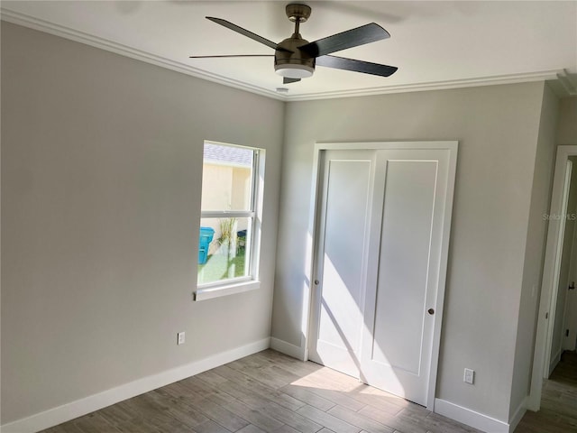 unfurnished bedroom with ceiling fan, light hardwood / wood-style flooring, and ornamental molding