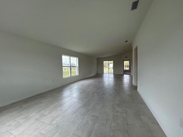 spare room with visible vents and baseboards