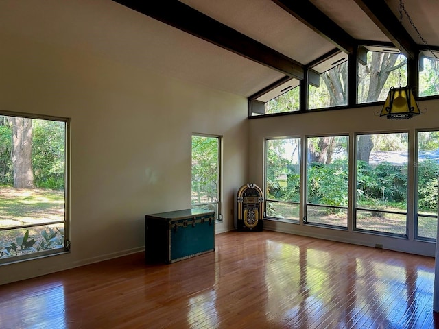 interior space featuring beamed ceiling, hardwood / wood-style floors, and high vaulted ceiling