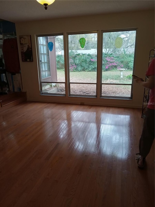 unfurnished living room with hardwood / wood-style floors and plenty of natural light