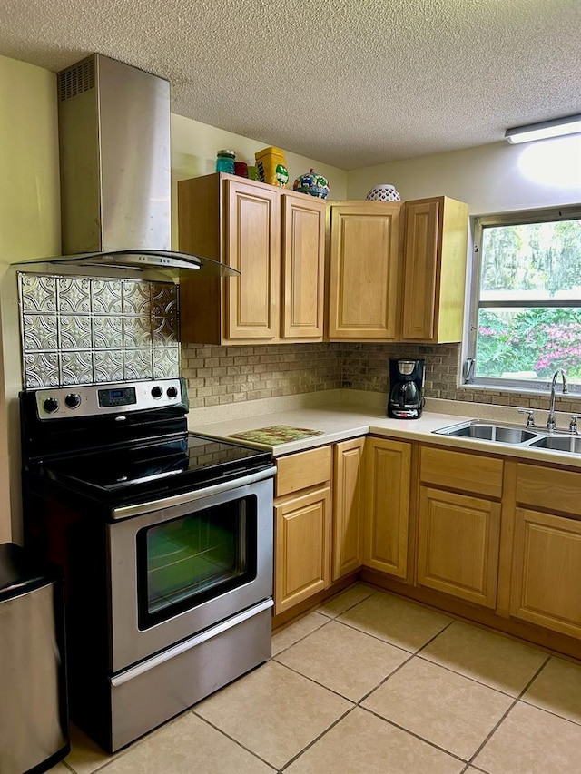 kitchen with stainless steel range with electric stovetop, sink, decorative backsplash, and range hood