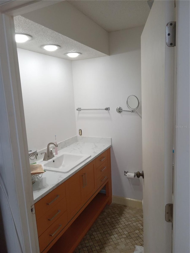 bathroom with vanity and a textured ceiling