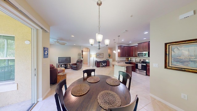 tiled dining room featuring ceiling fan with notable chandelier