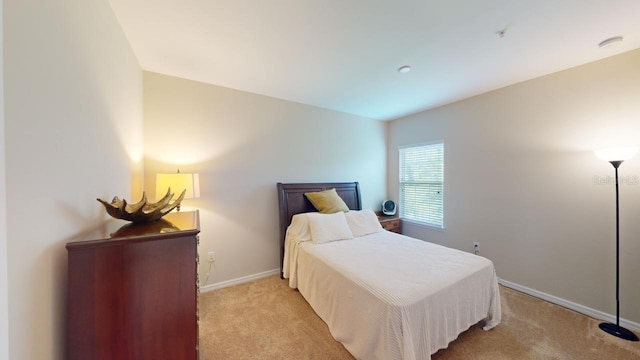 carpeted bedroom with lofted ceiling