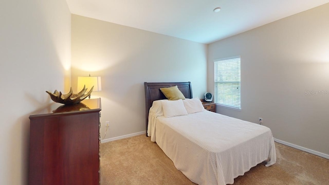 bedroom featuring light colored carpet