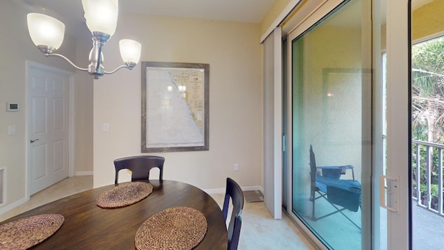 tiled dining room with a notable chandelier