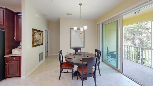 tiled dining space with a chandelier