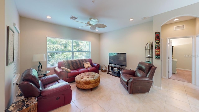 tiled living room with ceiling fan