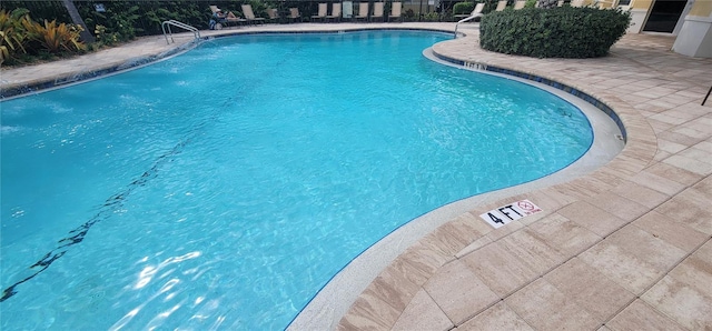 view of swimming pool with a patio