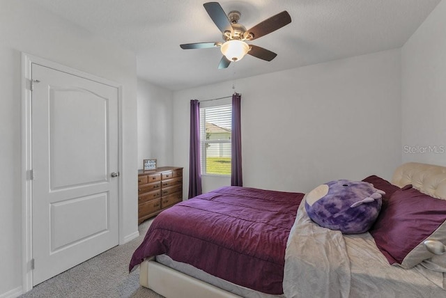 bedroom featuring ceiling fan and light colored carpet