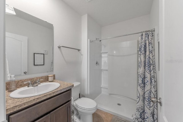 bathroom with a textured ceiling, toilet, vanity, and a shower with shower curtain