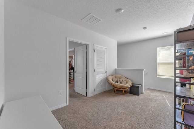 2557 Shamrock St, Tavares, FL 32778 - living area with carpet flooring, an upstairs landing, a textured ceiling, and baseboards