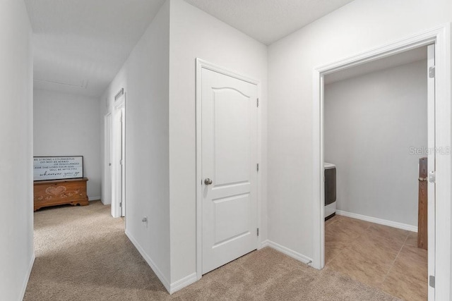 corridor featuring light colored carpet