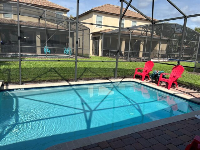 view of pool featuring a lanai and a yard