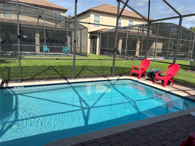 pool featuring a yard, a patio, and a lanai