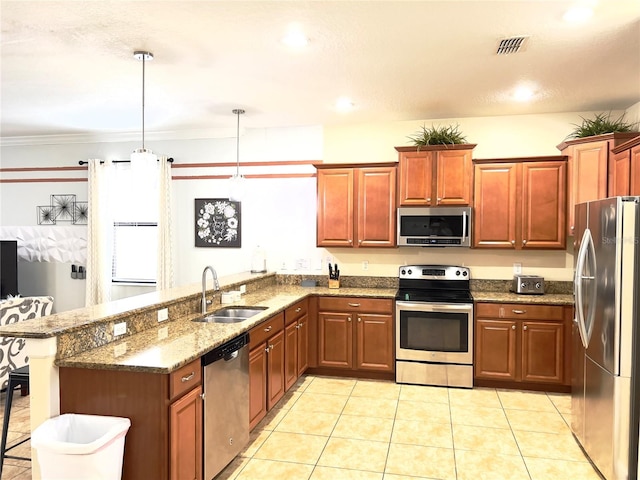 kitchen featuring a peninsula, visible vents, dark stone counters, stainless steel appliances, and a sink