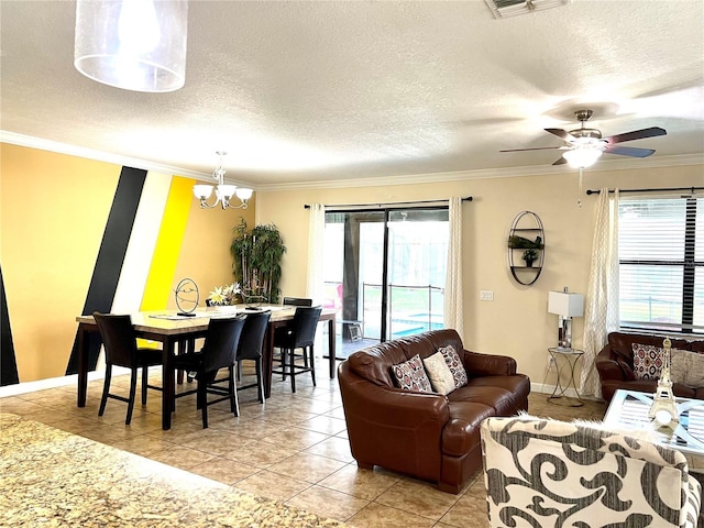 living area with ceiling fan with notable chandelier, light tile patterned floors, a textured ceiling, ornamental molding, and baseboards
