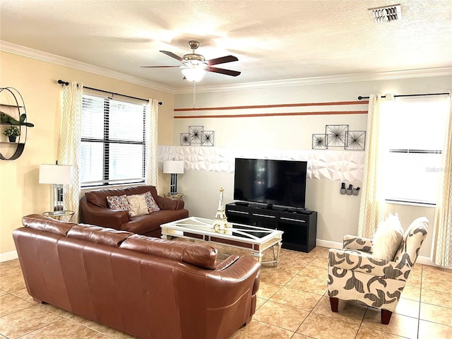 living area with baseboards, a textured ceiling, crown molding, a ceiling fan, and visible vents