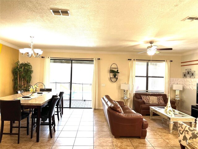 interior space featuring a textured ceiling, ceiling fan with notable chandelier, and ornamental molding