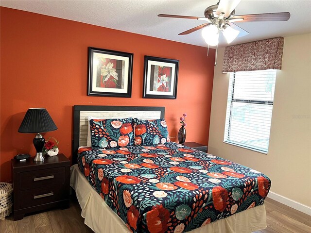 bedroom with wood-type flooring and ceiling fan