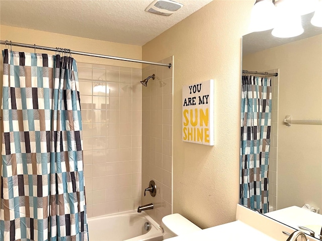 bathroom featuring visible vents, toilet, a textured wall, a textured ceiling, and shower / bath combo with shower curtain