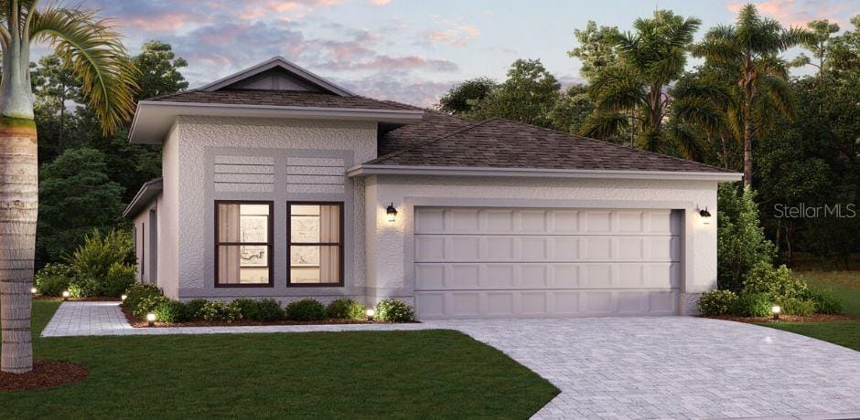 view of front facade featuring a lawn and a garage