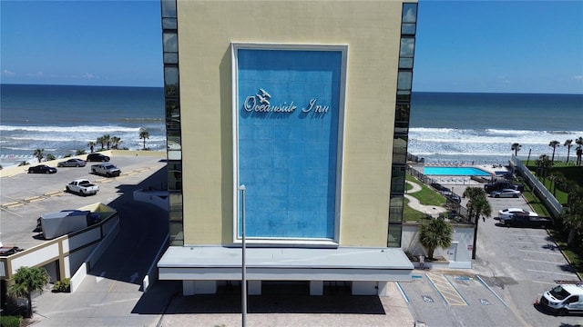 exterior space featuring a view of the beach and a water view