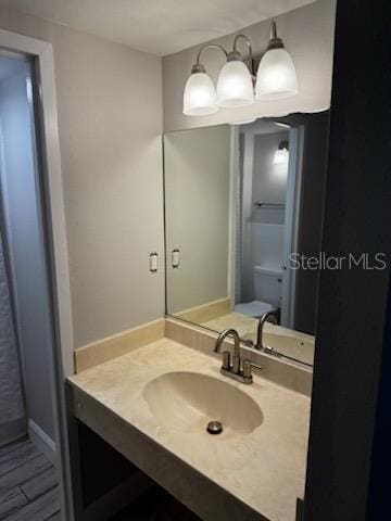 bathroom featuring vanity and toilet