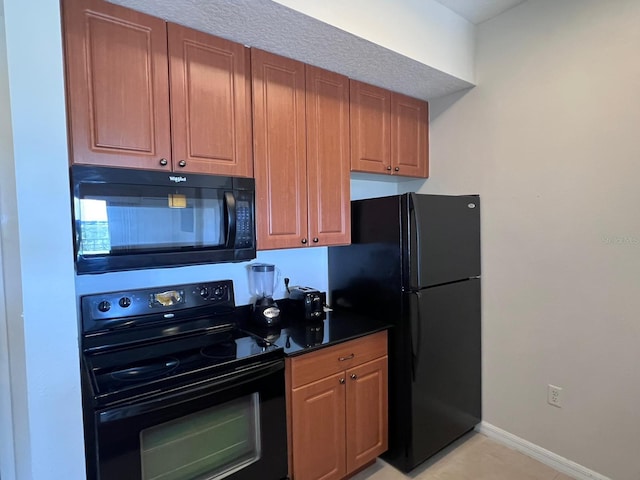 kitchen featuring black appliances and light tile patterned floors