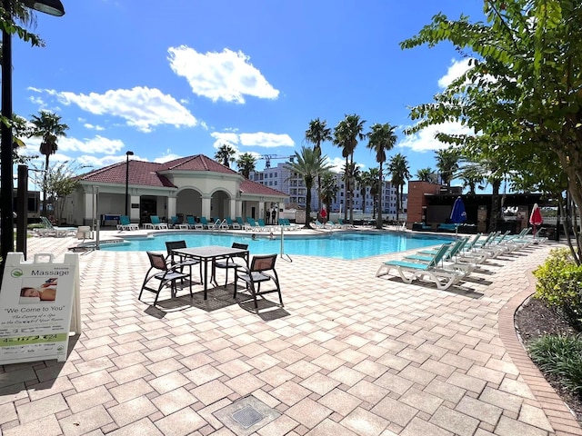 view of swimming pool with a patio