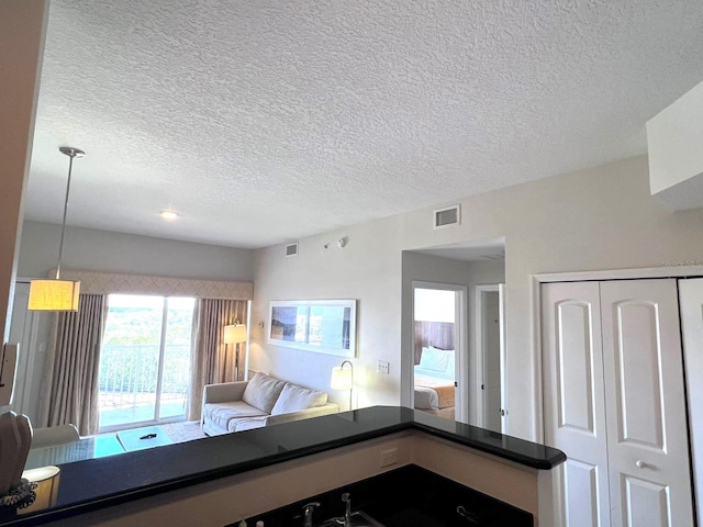 unfurnished living room featuring a textured ceiling