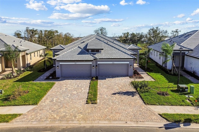 view of front of home featuring a front yard and a garage