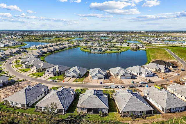 birds eye view of property with a water view