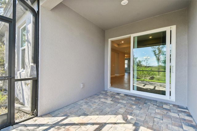 view of exterior entry featuring a patio area