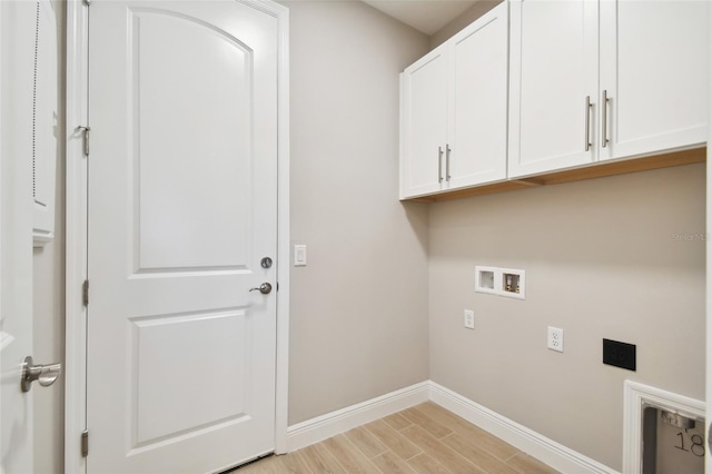 laundry room featuring hookup for a washing machine, light hardwood / wood-style flooring, and cabinets