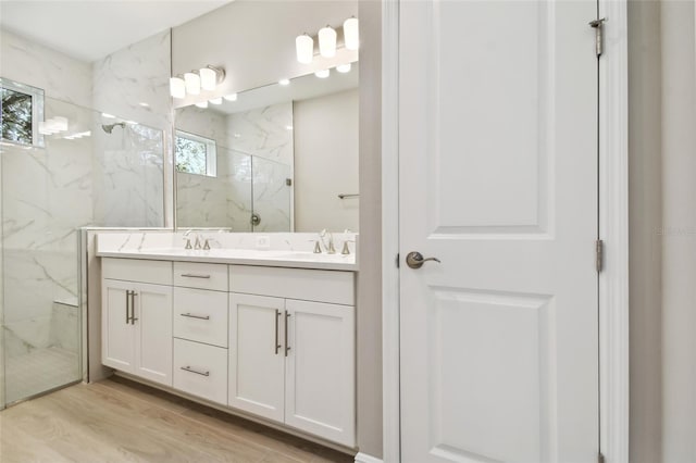 bathroom with vanity, hardwood / wood-style flooring, and walk in shower