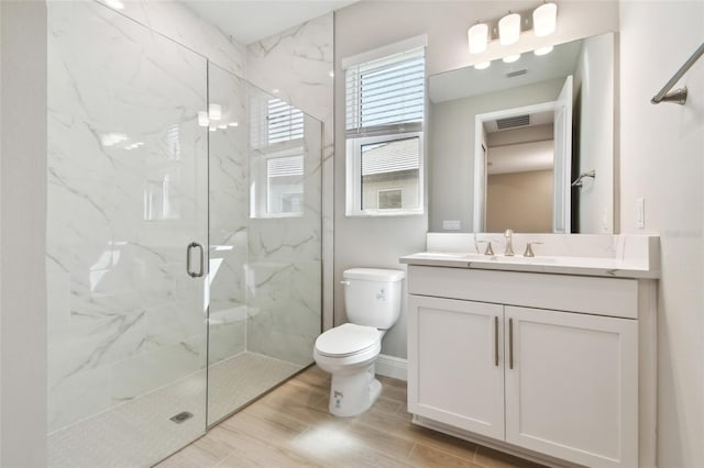 bathroom with vanity, hardwood / wood-style flooring, toilet, and an enclosed shower