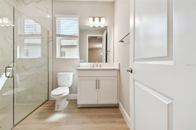 bathroom with vanity, a shower with shower door, wood-type flooring, and toilet