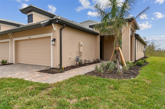 view of side of home with a garage and a yard